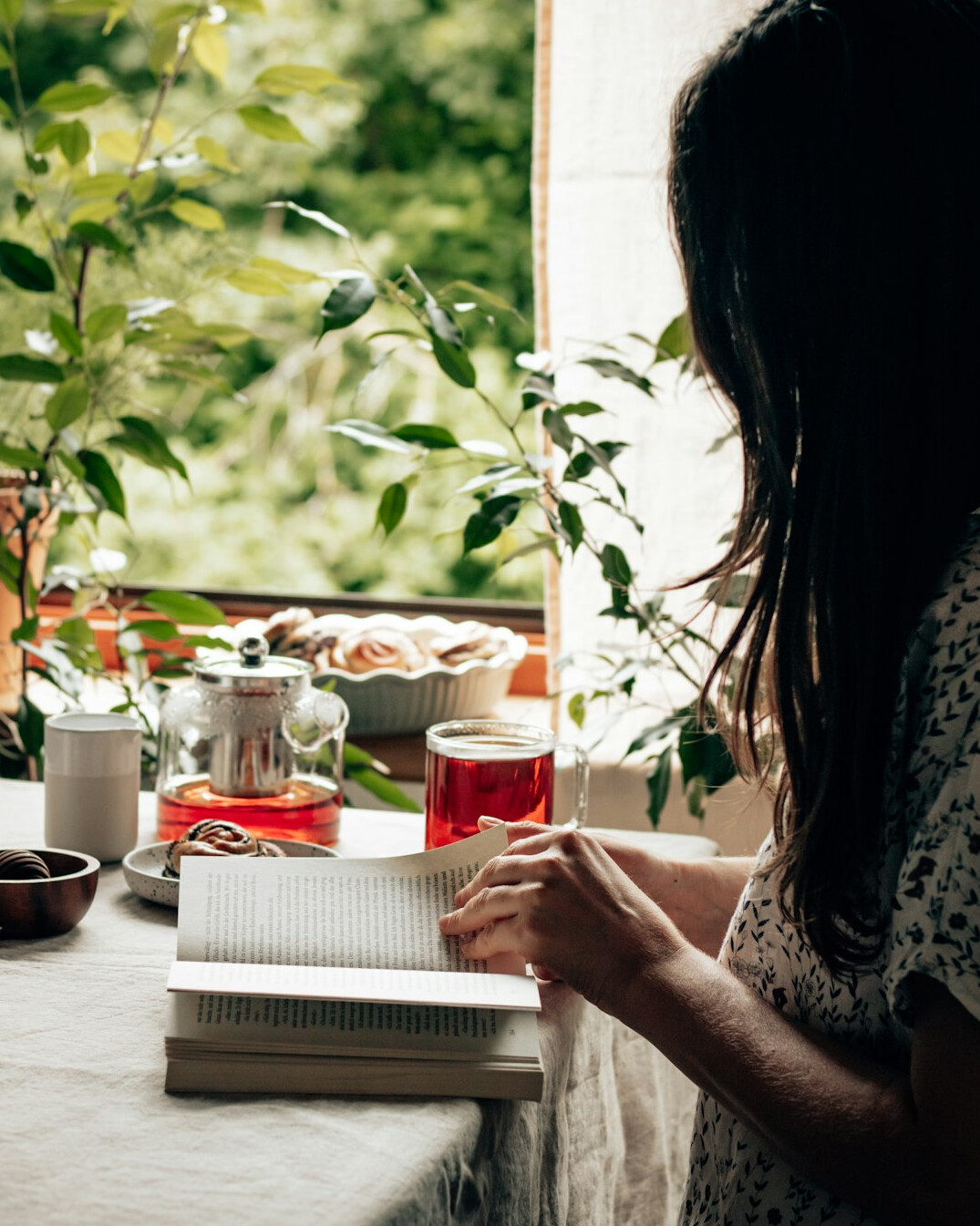 Brazilian woman writing notes in a journal at a desk
