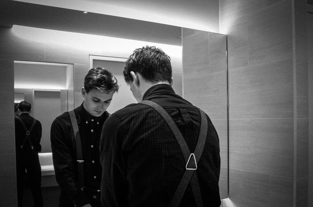 man practicing speech in mirror