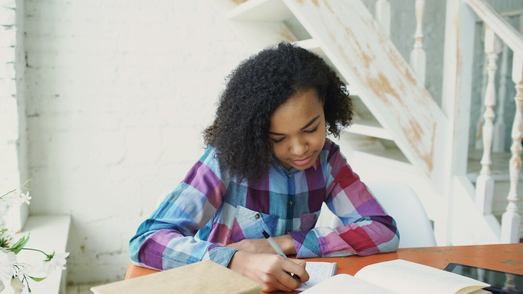 person journaling at desk
